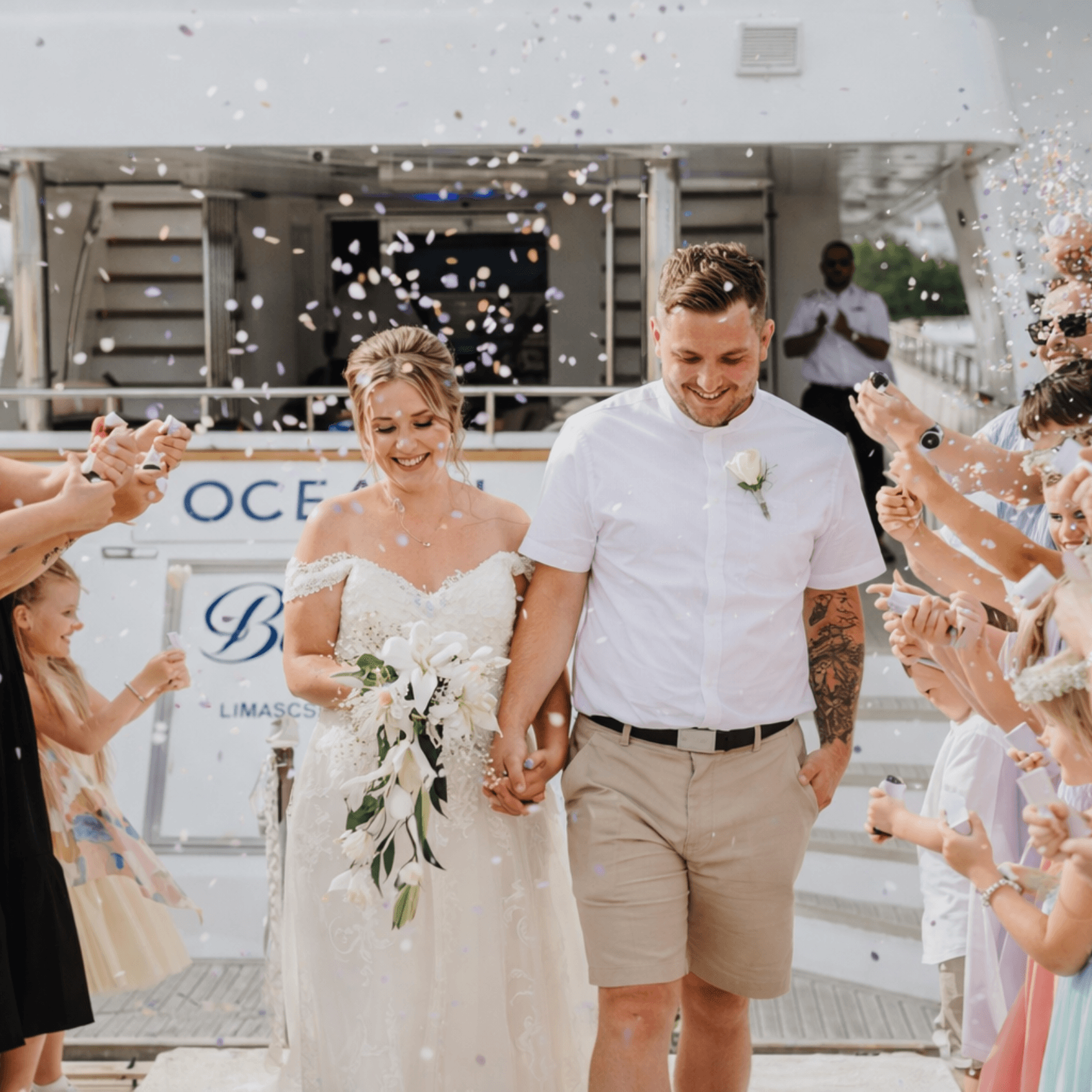 Newlyweds with confetti on yacht