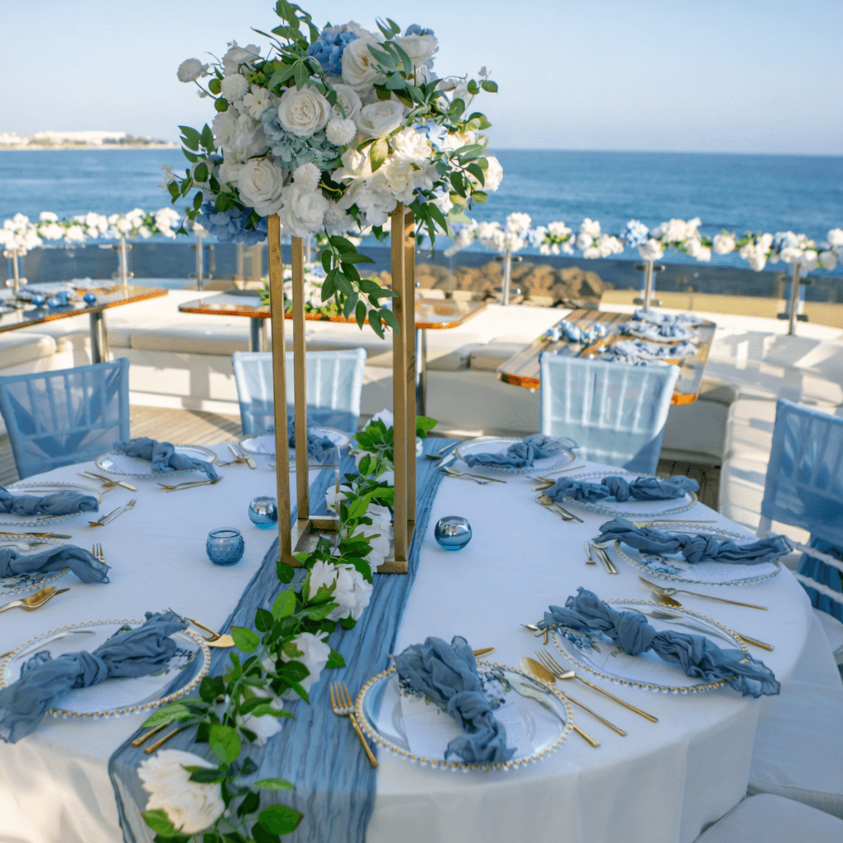 Elegant blue and white wedding table setup on yacht